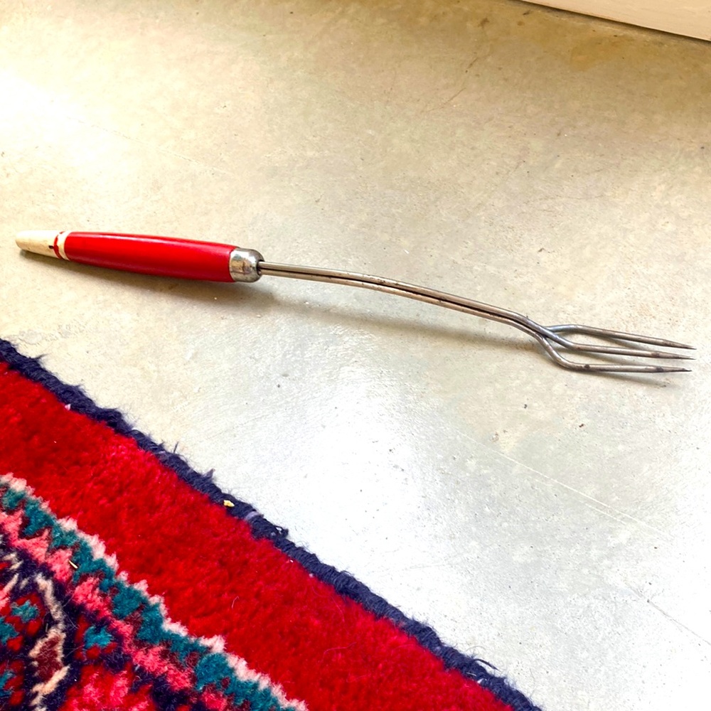 Mid century bbq fork with red enameled wood handle. So retro.